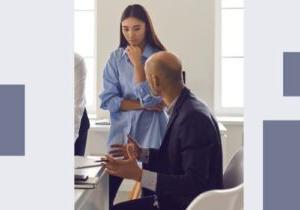 Photo: A male and female coworker appear to be having a tense conversation in an office setting.